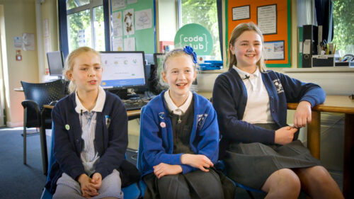 Three learners at a Code Club session.