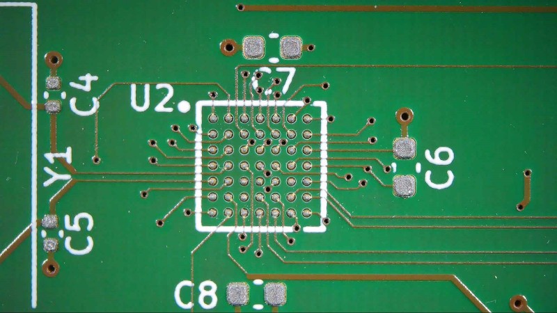An unpopulated PCB with a BGA footprint, with solder paste applied