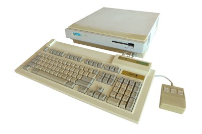 A beige desktop with no monitor, keyboard and mouse in front. It shows signs of yellowing with age.