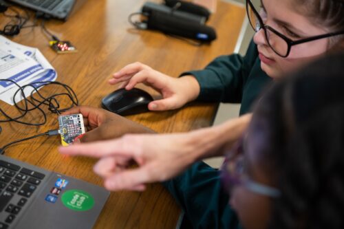 Kids coding a microbit project.